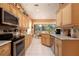 Open kitchen layout with stainless steel appliances, granite countertops, and plenty of natural light at 10488 Princess Ct, Punta Gorda, FL 33955