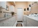 Functional laundry room with a washing machine, dryer, lots of cabinets, and granite countertops at 10488 Princess Ct, Punta Gorda, FL 33955
