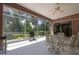The screened-in patio has a ceiling fan and outdoor dining set, perfect for enjoying outdoor meals at 10488 Princess Ct, Punta Gorda, FL 33955