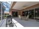 A screened-in patio boasts a ceiling fan, barbecue grill, and outdoor seating area at 10488 Princess Ct, Punta Gorda, FL 33955