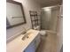 Bathroom with glass-enclosed shower, single sink vanity, and decorative shelving at 1051 Forrest Nelson Blvd # M 103, Port Charlotte, FL 33952