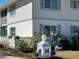 Well-maintained condo with turquoise shutters and landscaping provides curb appeal at 1051 Forrest Nelson Blvd # M 103, Port Charlotte, FL 33952