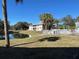 Exterior view of building overlooking pond with grass, trees and community pool area at 1051 Forrest Nelson Blvd # M 103, Port Charlotte, FL 33952