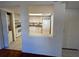 Kitchen with pass-through to living area, white cabinets and appliances, and tiled floor at 1051 Forrest Nelson Blvd # M 103, Port Charlotte, FL 33952