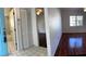 Open floor plan with dark wood floors leads to bath and bedroom at 1051 Forrest Nelson Blvd # M 103, Port Charlotte, FL 33952