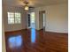 Open floor plan featuring laminate wood flooring, ceiling fan and natural light from the glass patio doors at 1051 Forrest Nelson Blvd # M 103, Port Charlotte, FL 33952