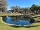 Tranquil pond scene with reflections of the neighborhood buildings and surrounding trees at 1051 Forrest Nelson Blvd # M 103, Port Charlotte, FL 33952