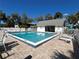 Community pool area with lounge chairs and shade umbrellas at 1051 Forrest Nelson Blvd # M 103, Port Charlotte, FL 33952