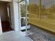 View of screened porch with tiled floor and bamboo shade looking out to yard at 1051 Forrest Nelson Blvd # M 103, Port Charlotte, FL 33952