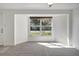 Cozy living area with large window offering views of the outdoors and neutral carpet at 1052 Archer St, Port Charlotte, FL 33952