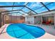 The screened pool boasts ample room for swimming and has an attached outdoor seating area at 1052 Archer St, Port Charlotte, FL 33952