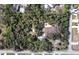 Aerial view of a property, featuring a pool and gazebo, nestled within a lush, tree-filled landscape at 1055 & 1075 Yorkshire St St, Port Charlotte, FL 33952