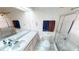 Bright bathroom featuring a shower, a mirrored wall with vanity and tiled flooring at 1055 & 1075 Yorkshire St St, Port Charlotte, FL 33952