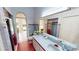 A colorful bathroom with a single sink, a toilet, and a shower, with a glass door to the lanai at 1055 & 1075 Yorkshire St St, Port Charlotte, FL 33952