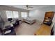 Inviting bedroom bathed in sunlight boasts a ceiling fan, a desk, and a full bookcase at 1055 & 1075 Yorkshire St St, Port Charlotte, FL 33952