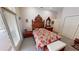 The room features a unique wooden headboard on the bed and has a door leading out to the lanai at 1055 & 1075 Yorkshire St St, Port Charlotte, FL 33952
