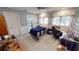 Cozy bedroom with blue accents, a ceiling fan, a desk and an adjacent private bathroom at 1055 & 1075 Yorkshire St St, Port Charlotte, FL 33952
