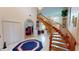 Elegant entryway with a curved staircase, white tile floors, and a view into a cozy sitting room at 1055 & 1075 Yorkshire St St, Port Charlotte, FL 33952