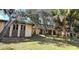 A charming home with mature trees, a well-manicured lawn and a brick facade at 1055 & 1075 Yorkshire St St, Port Charlotte, FL 33952