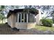 Home exterior featuring a sunroom framed by large windows for ample natural light and views of the property at 1055 & 1075 Yorkshire St St, Port Charlotte, FL 33952