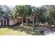 Charming building with classic brick accents and lush, mature trees surrounding the property at 1055 & 1075 Yorkshire St St, Port Charlotte, FL 33952