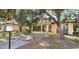 Exterior of home with a well-maintained lawn and mature trees and front entryway at 1055 & 1075 Yorkshire St St, Port Charlotte, FL 33952