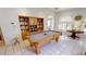 Game room features pool table, built-in bookcase, and natural light at 1055 & 1075 Yorkshire St St, Port Charlotte, FL 33952