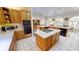Open kitchen with wooden cabinets, island cooktop, and stainless steel appliances at 1055 & 1075 Yorkshire St St, Port Charlotte, FL 33952