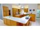 Well-lit kitchen features wooden cabinetry, an island with a sink, and ample counter space at 1055 & 1075 Yorkshire St St, Port Charlotte, FL 33952