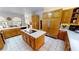 Spacious kitchen with wood cabinets, island cooktop, and white countertops at 1055 & 1075 Yorkshire St St, Port Charlotte, FL 33952