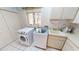 Laundry room with modern appliances, a sink, and storage, blending functionality with home comfort at 1055 & 1075 Yorkshire St St, Port Charlotte, FL 33952