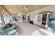 Spacious living area featuring tile flooring, a comfortable sofa, and French doors for abundant natural light at 1055 & 1075 Yorkshire St St, Port Charlotte, FL 33952