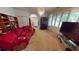 Cozy living room featuring a large sofa, built-in bookshelves, and a window with tree views at 1055 & 1075 Yorkshire St St, Port Charlotte, FL 33952