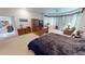 Main bedroom boasts a sitting area, large windows, and neutral carpet at 1055 & 1075 Yorkshire St St, Port Charlotte, FL 33952
