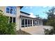 Rear exterior of home with expansive sunroom featuring numerous windows for abundant natural light at 1055 & 1075 Yorkshire St St, Port Charlotte, FL 33952