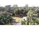 View of home through the trees highlighting the beautiful landscaping and the surrounding natural environment at 1055 & 1075 Yorkshire St St, Port Charlotte, FL 33952