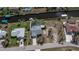 Aerial view of waterfront property, showcasing the house, pool, dock, and canal access at 129 Barre Nw Dr, Port Charlotte, FL 33952