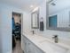 Bright bathroom features double sinks, white cabinetry, and a walk-in closet at 129 Barre Nw Dr, Port Charlotte, FL 33952