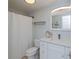 Bright bathroom with a white vanity, stylish mirror, and shower with white curtain at 129 Barre Nw Dr, Port Charlotte, FL 33952