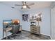 Sun-lit bedroom with a desk, computer, and artwork adorning the walls at 129 Barre Nw Dr, Port Charlotte, FL 33952