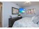 Cozy bedroom with ceiling fan, flatscreen TV, and wood-look dresser at 129 Barre Nw Dr, Port Charlotte, FL 33952