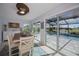 Dining area with large windows that view the screened-in pool area at 129 Barre Nw Dr, Port Charlotte, FL 33952