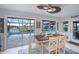 Dining area with views of the pool, stylish ceiling fan and coastal decor at 129 Barre Nw Dr, Port Charlotte, FL 33952