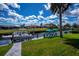 Canal-front property boasts a private boat dock with inviting Adirondack chairs, perfect for waterfront enjoyment at 129 Barre Nw Dr, Port Charlotte, FL 33952