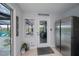 Bright entryway features tile flooring, stainless steel refrigerator, and views of the outdoor lounge area at 129 Barre Nw Dr, Port Charlotte, FL 33952