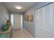 Inviting foyer with tile flooring, coastal-themed decor, and ample closet space at 129 Barre Nw Dr, Port Charlotte, FL 33952