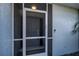 Close-up of the front door and screen enclosure of this waterfront home at 129 Barre Nw Dr, Port Charlotte, FL 33952