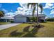 Beautiful single-story home featuring a garage, landscaped yard, and well-maintained exterior at 129 Barre Nw Dr, Port Charlotte, FL 33952