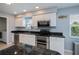 Functional kitchen featuring stainless steel appliances, granite countertops, and a bright window at 129 Barre Nw Dr, Port Charlotte, FL 33952