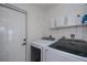 Convenient laundry room with modern machines and ample storage space at 129 Barre Nw Dr, Port Charlotte, FL 33952